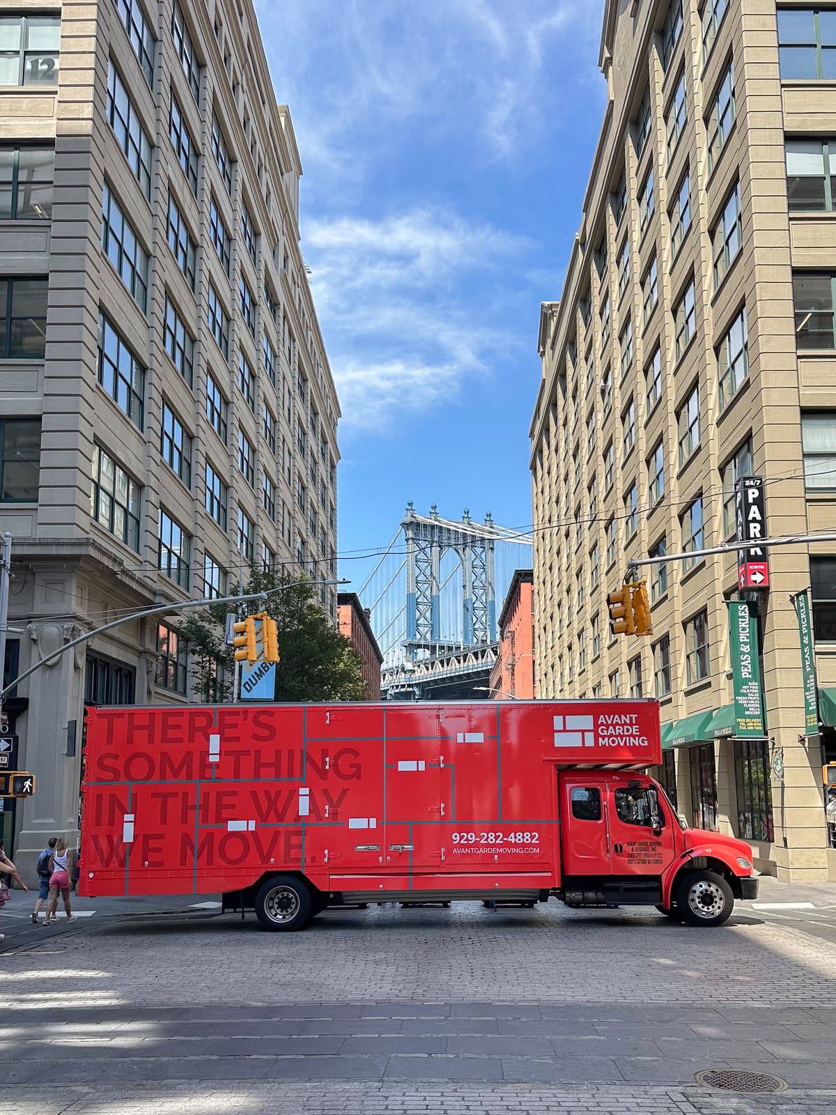 Williamsburg movers carrying furniture down a no-elevator loft stairwell near Bedford Avenue