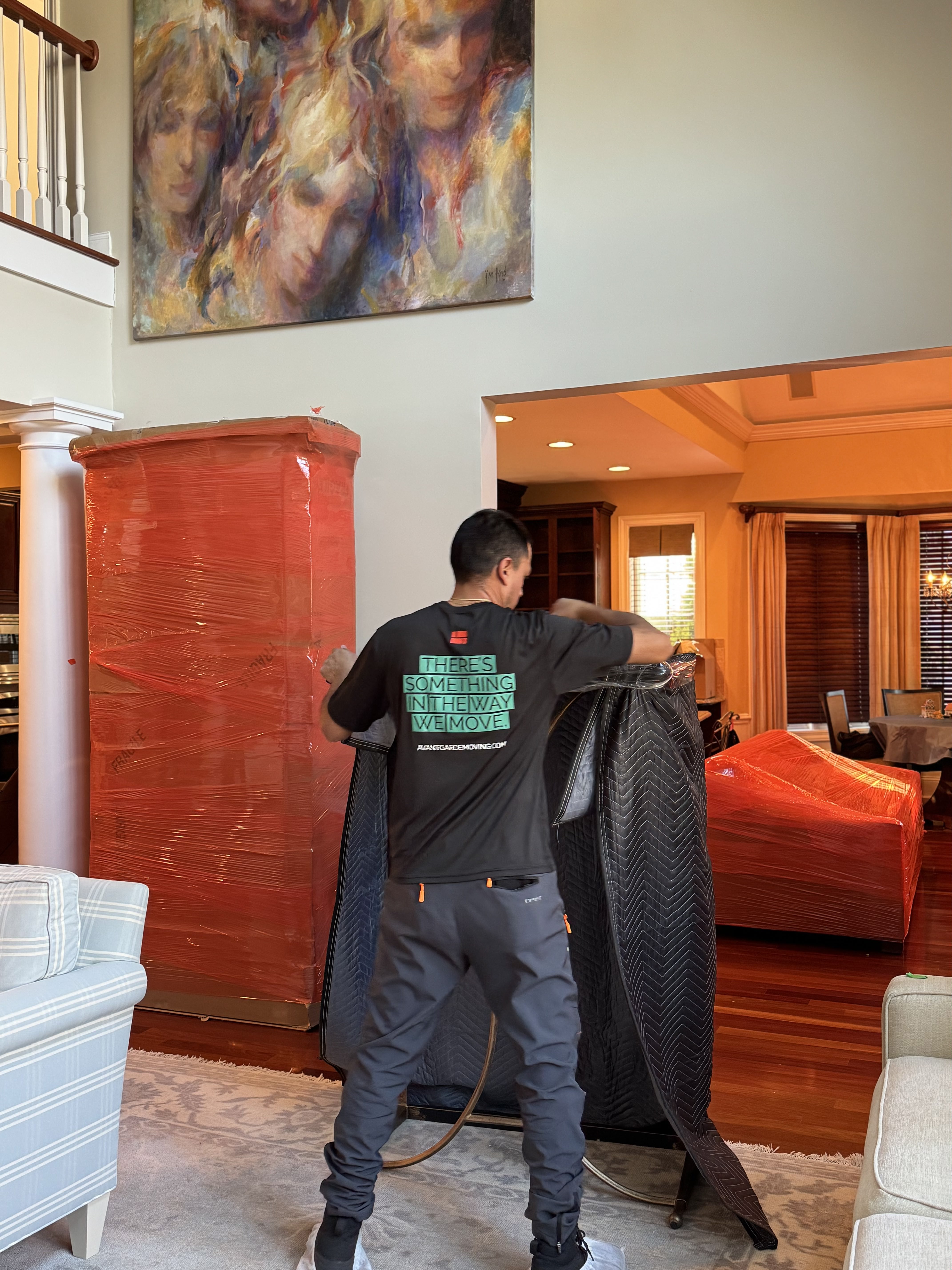 Professional movers carefully wrapping furniture for protection