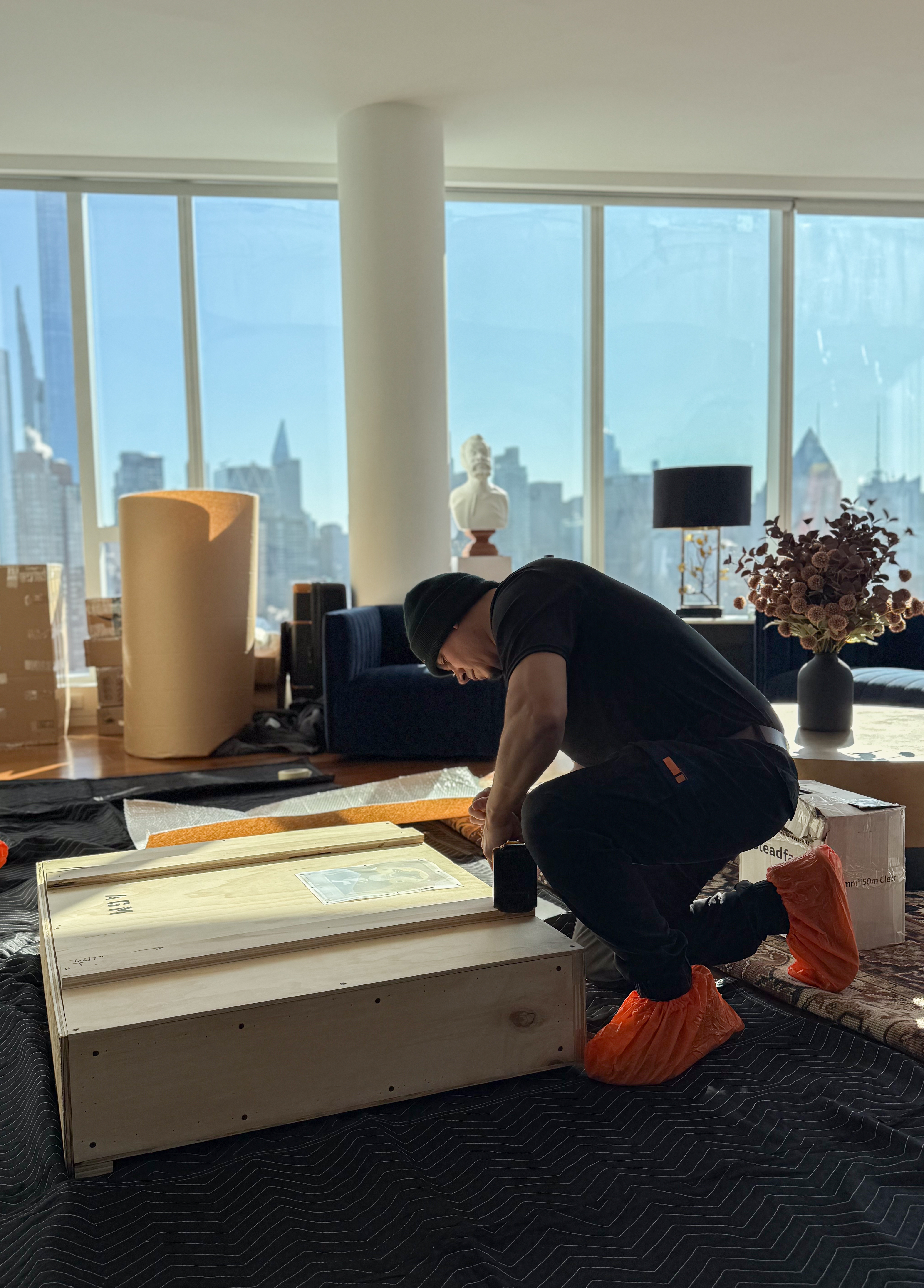 Professional movers handling custom crated items